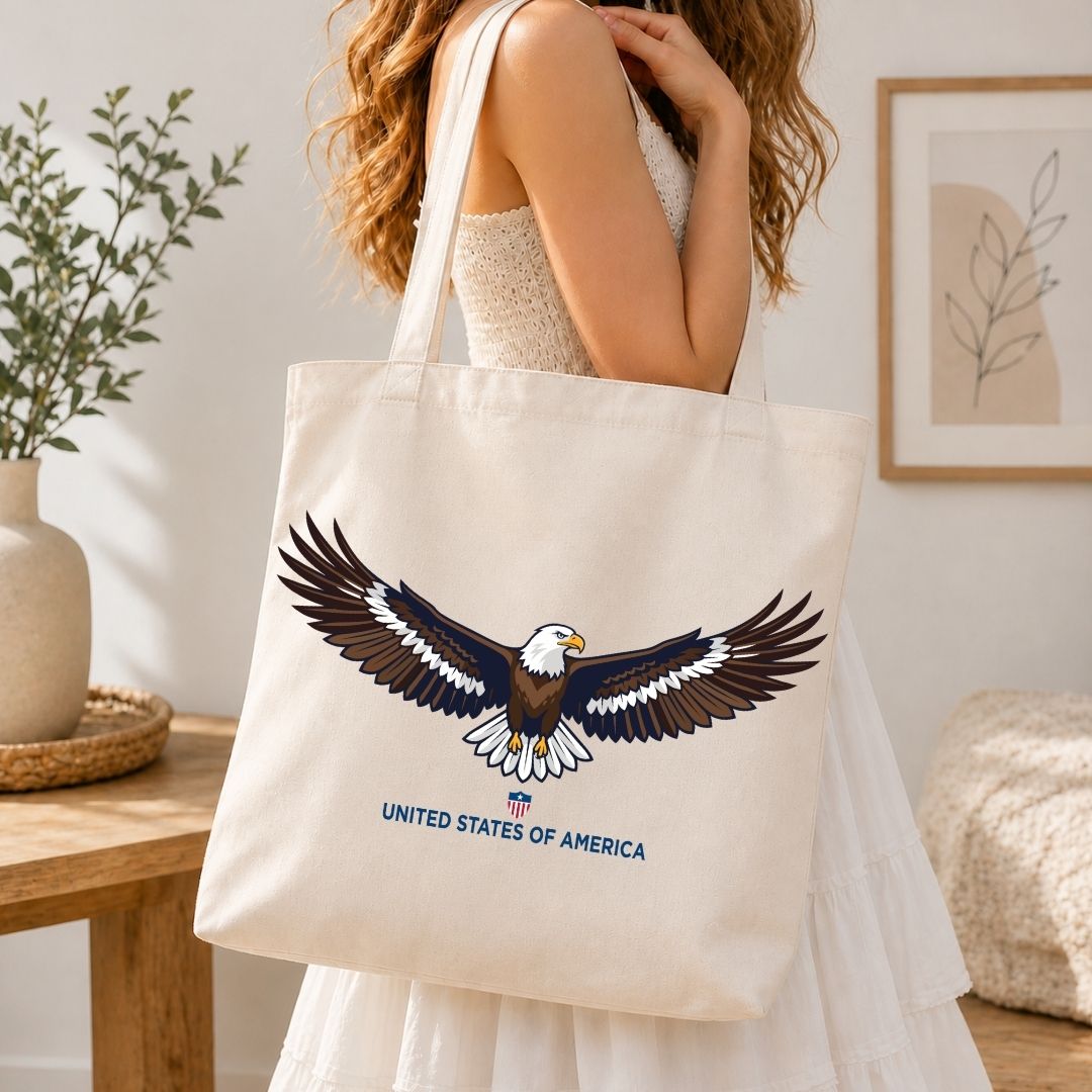 Person holding a tote bag with an eagle design and 'United States of America' text in a home setting.