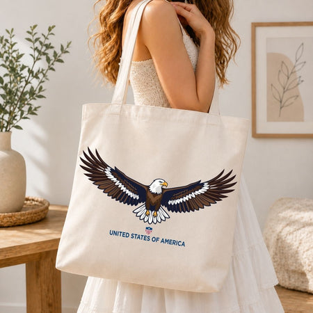 Person holding a tote bag with an eagle design and 'United States of America' text in a home setting.