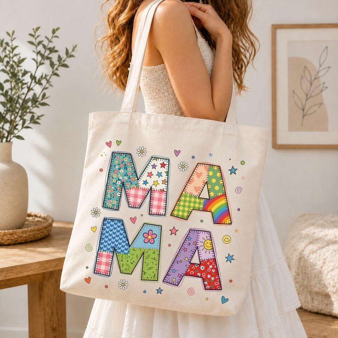 Person holding a tote bag with colorful letters spelling 'MAMA' in a home setting.