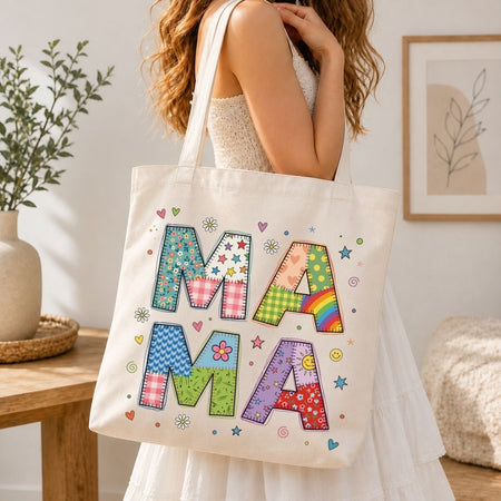 Person holding a tote bag with colorful letters spelling 'MAMA' in a home setting.