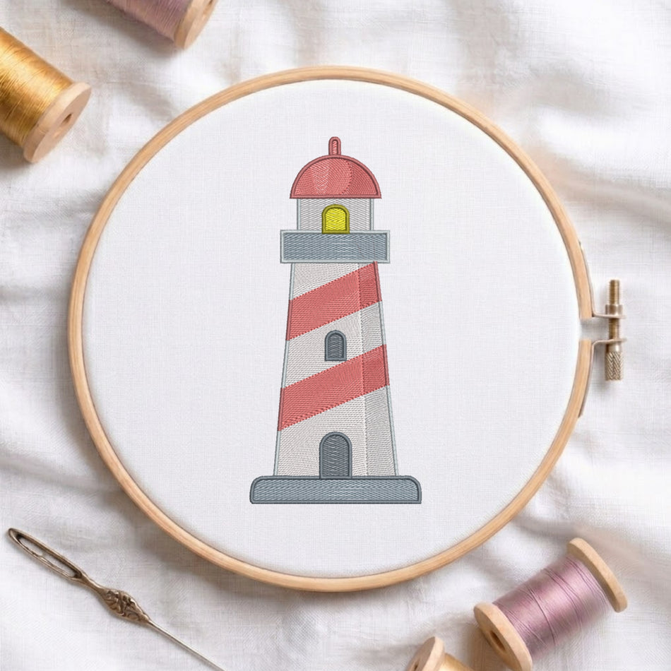 A circular embroidery hoop holding white fabric with a stitched lighthouse design. The lighthouse has red and white diagonal stripes, a gray base, a red dome, and a small yellow window.