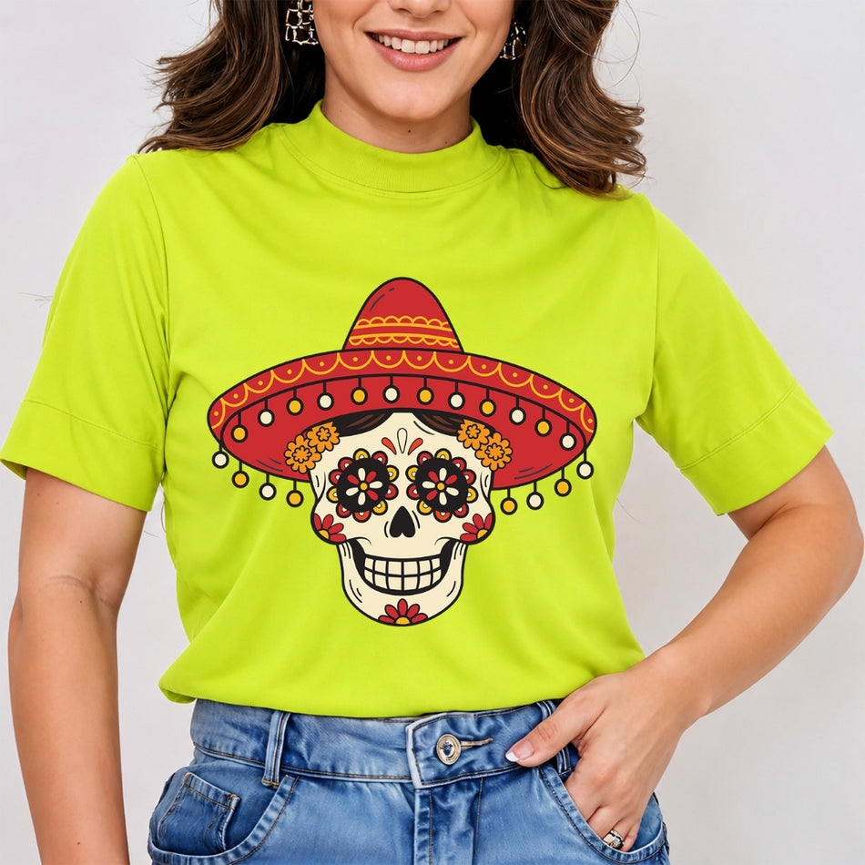 A woman wearing a bright lime green mock-neck t-shirt with a colorful sugar skull graphic wearing a red sombrero, paired with blue jeans.