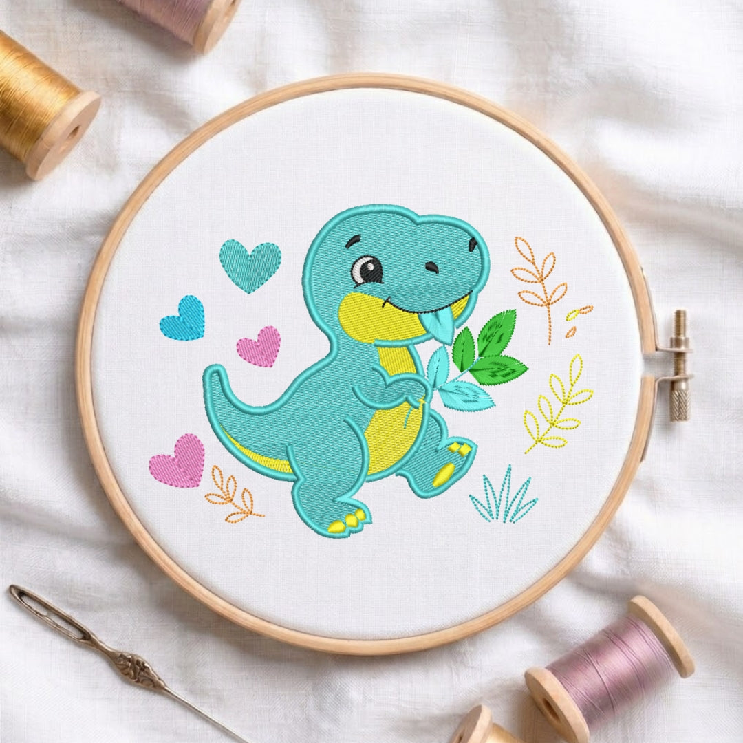 A colorful embroidered turquoise t-rex dinosaur holding a green leaf, surrounded by embroidered hearts and leaves inside a wooden embroidery hoop.