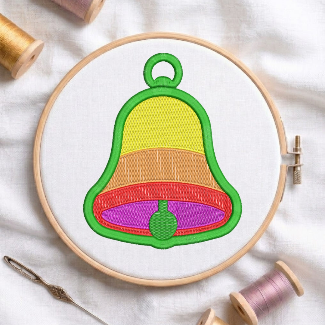 Embroidery hoop with a colorful bell design on a white fabric background.