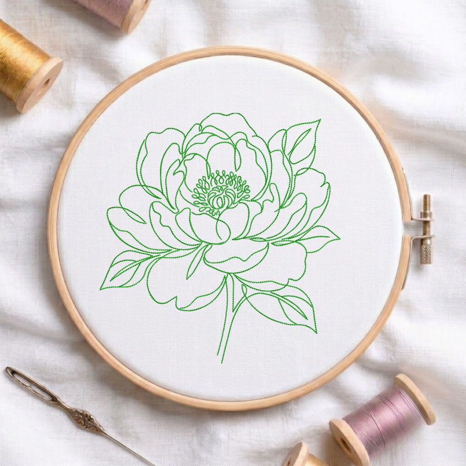 Green floral embroidery design stitched in hoop frame