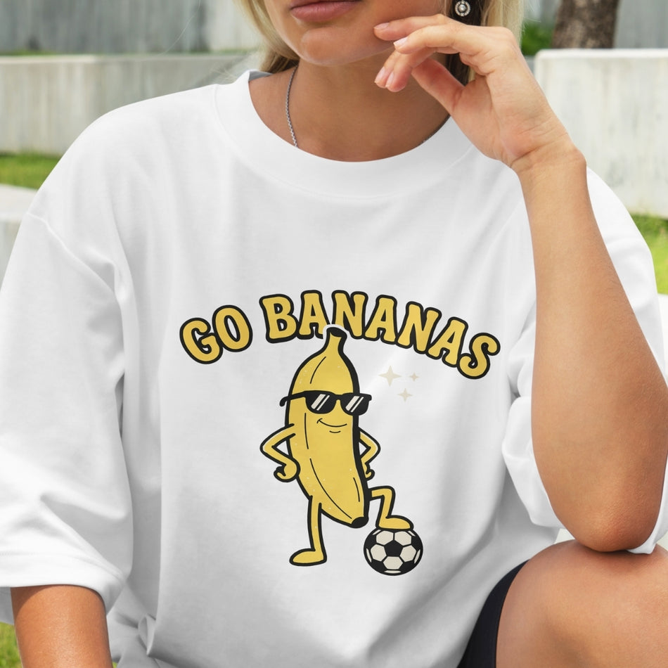 Person wearing a white t-shirt with a cartoon banana graphic and 'GO BANANAS' text.
