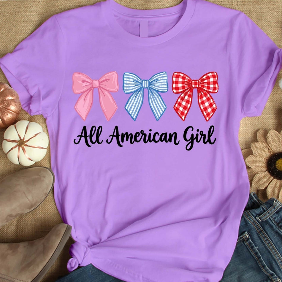 Purple t-shirt with three bows and 'All American Girl' text on a textured surface.