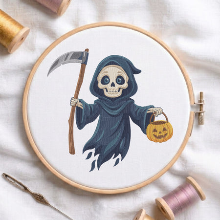 A circular embroidery hoop displays a stitched design of a skeleton in a dark blue hood holding a scythe and a jack-o'-lantern bucket. The hoop is styled on a white fabric background with spools of thread, a needle, and wooden embroidery hoops.