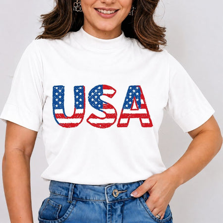 Person wearing a white t-shirt with 'USA' printed in red, blue, and white on a plain background