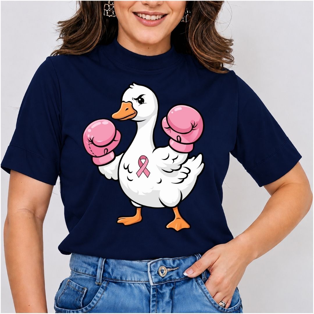 Close-up mockup of a woman wearing a dark navy blue t-shirt printed with a cartoon duck wearing pink boxing gloves and a breast cancer awareness pink ribbon.