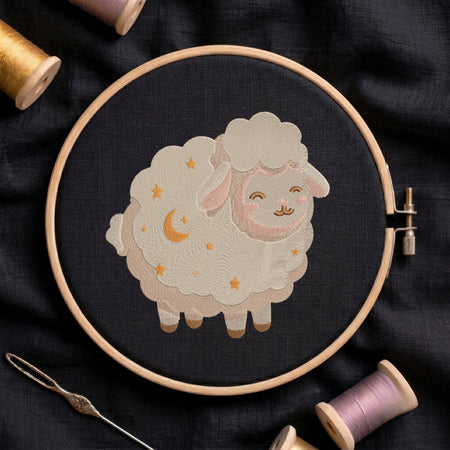 A circular embroidery hoop holding dark fabric with a stitched cartoon sheep design in cream, pink, and gold thread. A needle and spools of thread are arranged around it on a dark fabric background.