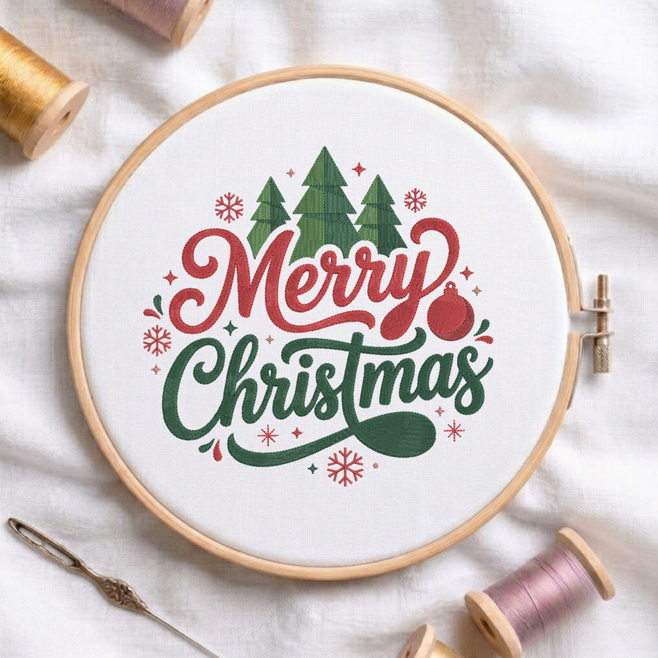 A circular embroidery hoop on white fabric, featuring a festive 'Merry Christmas' design with green trees, red lettering, and a red ornament. Spools of thread and a needle are arranged around it.