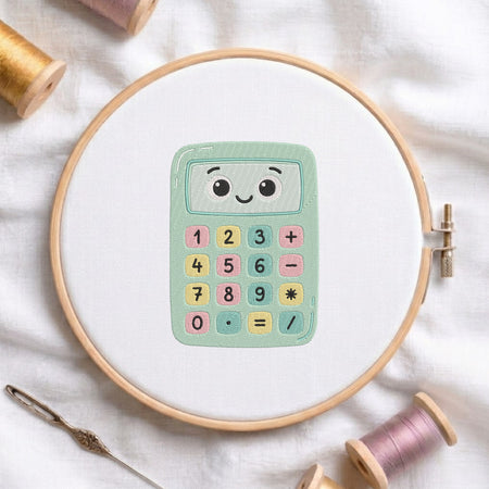 A wooden embroidery hoop holds a white fabric with a colorful cartoon calculator design in the center. The scene is styled with spools of thread and a needle on a soft white fabric background.