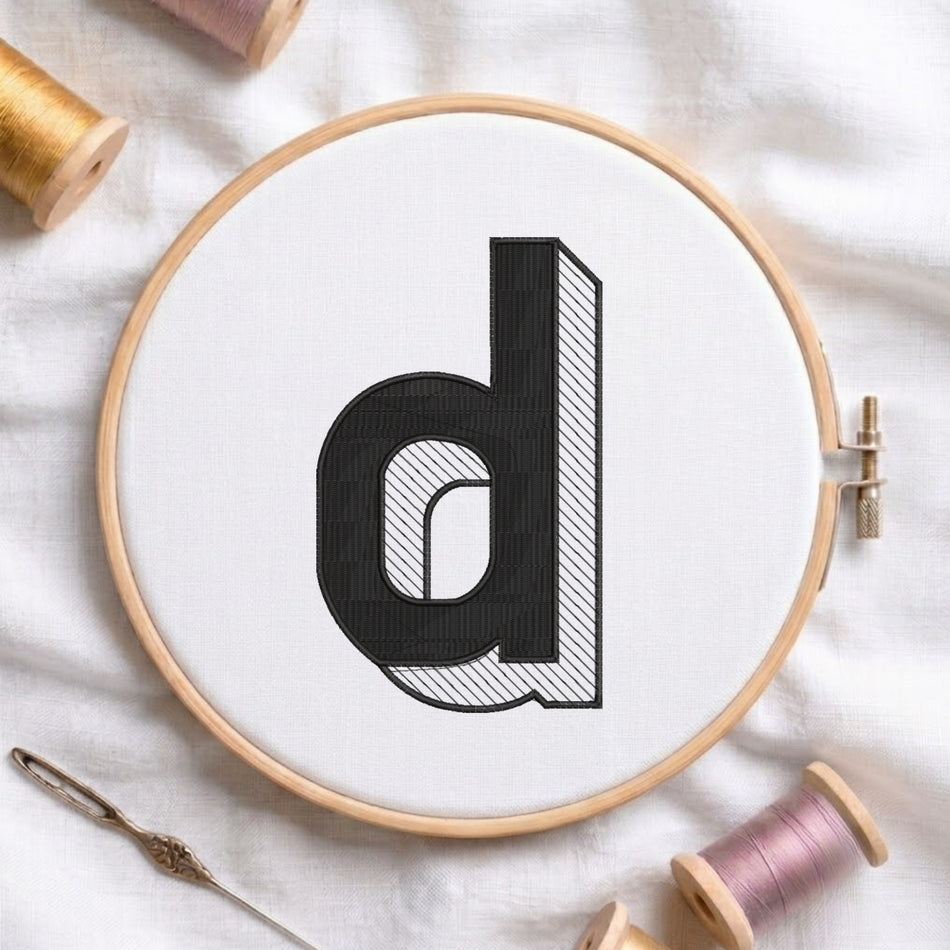 An embroidered 3D block lowercase letter "d" with striped shading texture, stitched inside a wooden hoop on white fabric with sewing threads.