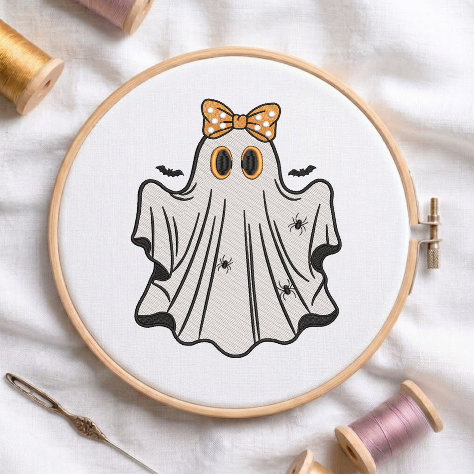 Embroidered friendly Halloween ghost wearing an orange polka dot bow in a wooden hoop.