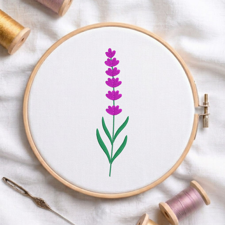 Purple lavender stalk with green leaves embroidered inside a round wooden hoop with thread spools.