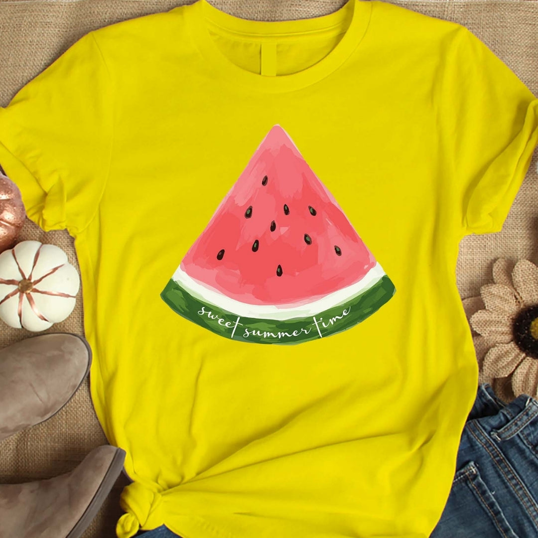 Yellow t-shirt with a watermelon slice design on a textured surface.