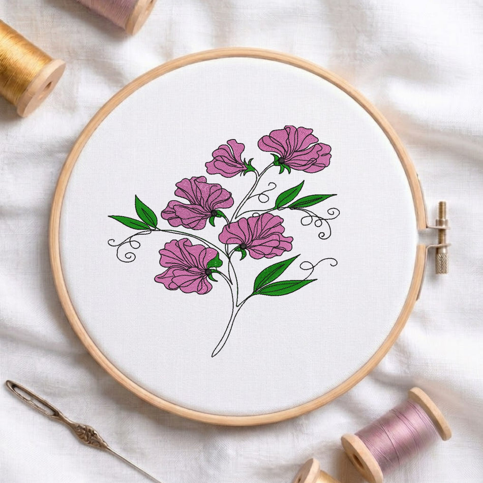 Sweet pea flower embroidery design inside a wooden hoop showing pink blossoms, green leaves, and black line work.