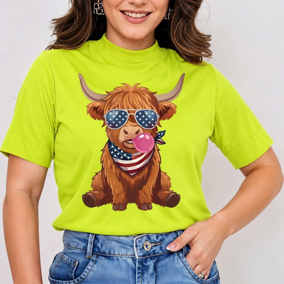 Person wearing a bright green t-shirt with a cartoon Highland cow design, sunglasses, and an American flag bandana.