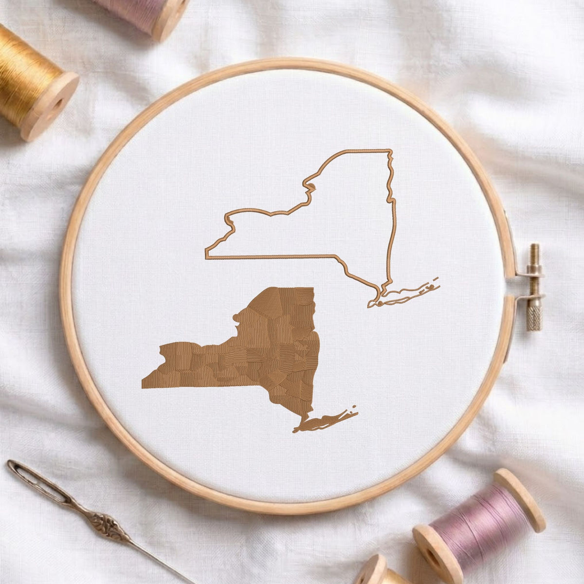 New York state map fill and outline machine embroidery design, displayed in a wooden hoop on white fabric with thread spools and a needle.