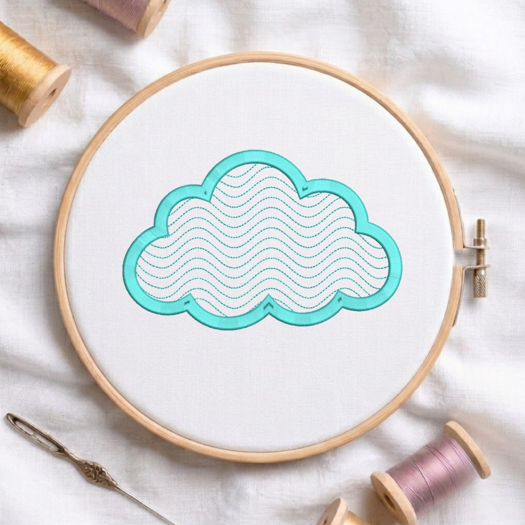 A wooden embroidery hoop holding white fabric with a cloud-shaped applique outlined in turquoise and filled with wavy stitched lines. Spools of thread and a needle are arranged around it on a white fabric background.