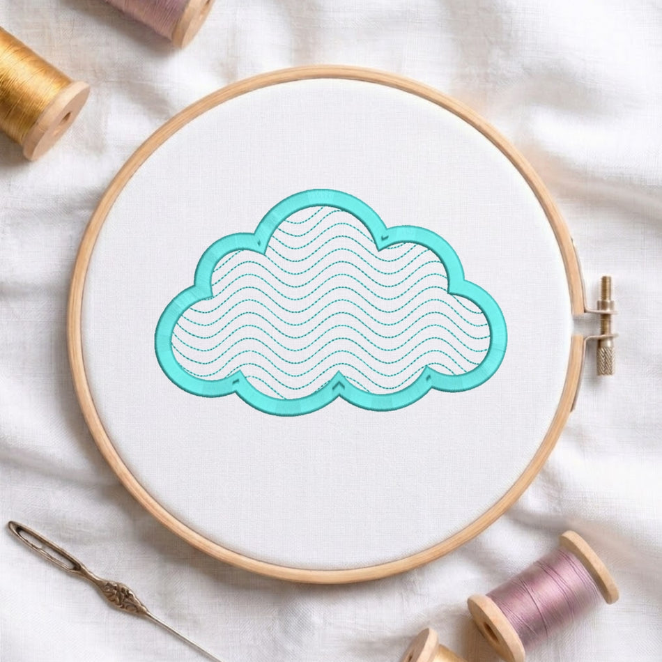 A wooden embroidery hoop holding white fabric with a cloud-shaped applique outlined in turquoise and filled with wavy stitched lines. Spools of thread and a needle are arranged around it on a white fabric background.