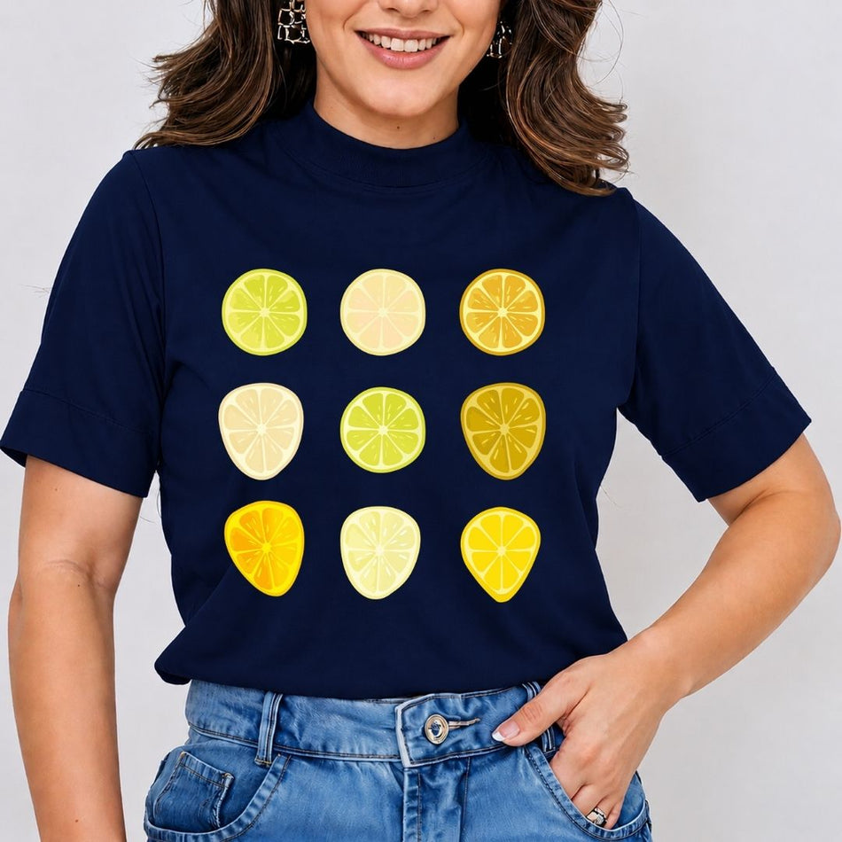 A woman wearing a navy blue short-sleeve t-shirt with a graphic of nine citrus slice designs in yellow, green, and pale yellow, paired with blue jeans.