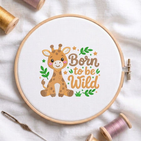"Born to be wild" cute safari baby giraffe machine embroidery design displayed in a wooden hoop on white fabric with thread spools and a needle
