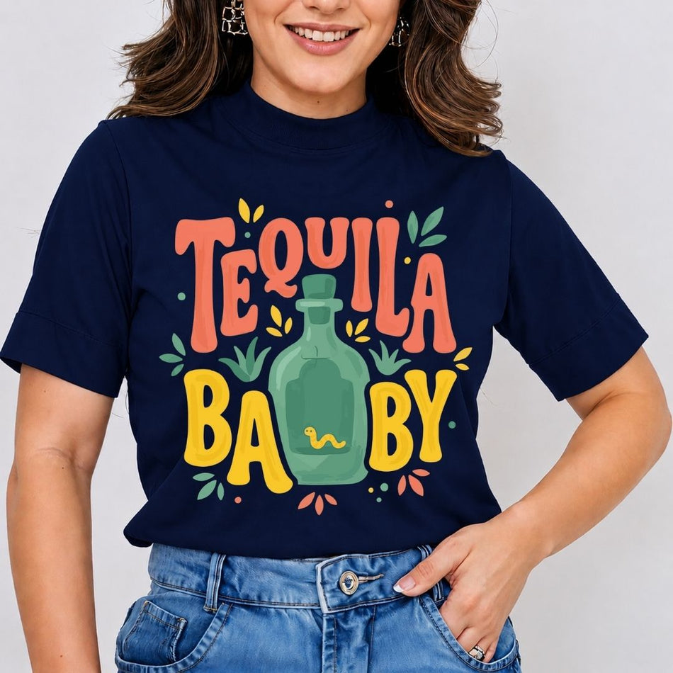 A smiling woman wearing a navy blue mock-neck t-shirt featuring a retro "Tequila Baby" text graphic with a green liquor bottle printed on the front.