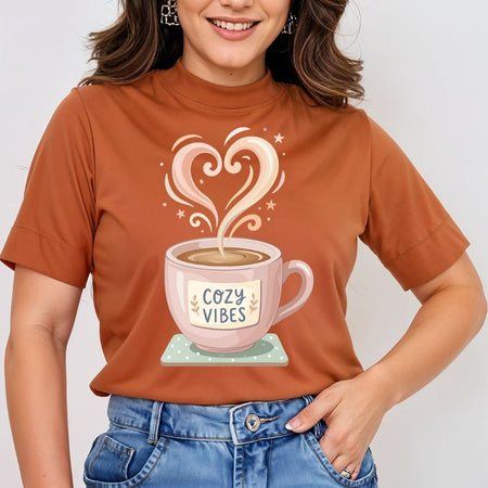 Person wearing a brown t-shirt with a coffee cup graphic and 'Cozy Vibes' text.