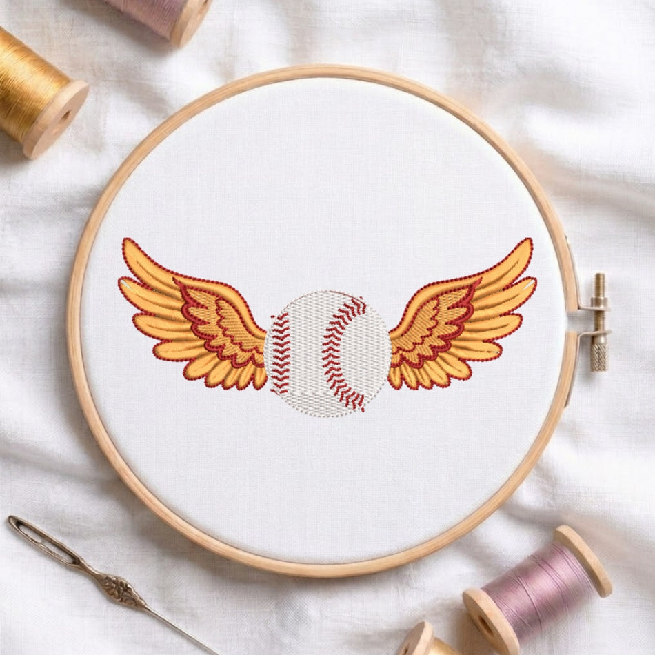 Embroidery hoop with a baseball and wings design on a white fabric background.