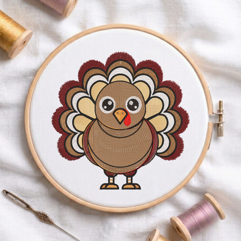 A round embroidery hoop holding white fabric with a cartoon turkey design in brown, beige, red, and white thread. Spools of thread and a needle are arranged around it on a white fabric background.