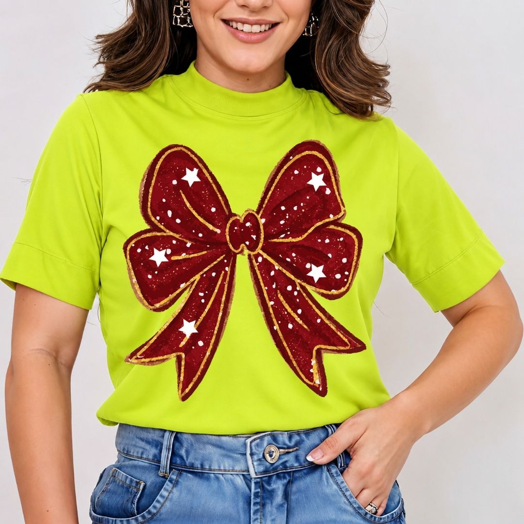 Person wearing a bright green t-shirt with a large red bow design on a plain background