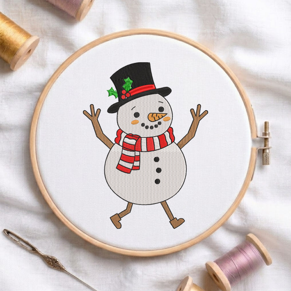 A circular embroidery hoop holding a white fabric panel with a cartoon snowman design. The snowman wears a black top hat with green holly leaves and a red band, a red-and-white striped scarf, and brown limbs.