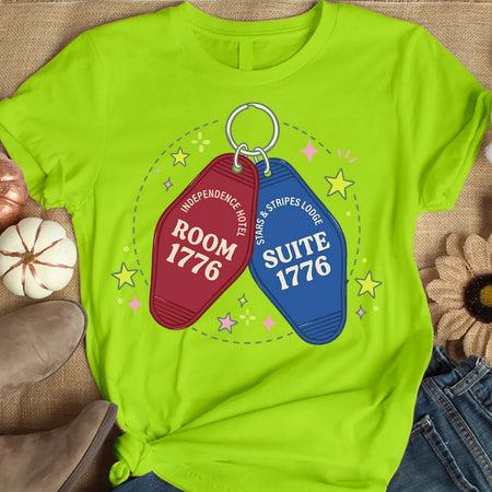 Lime green t-shirt with motel keychain graphic on a textured surface.