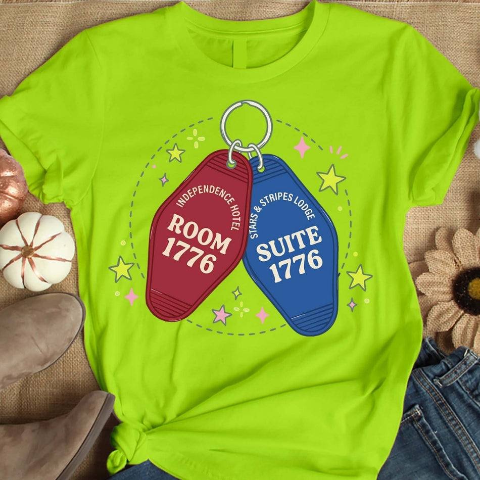 Lime green t-shirt with motel keychain graphic on a textured surface.