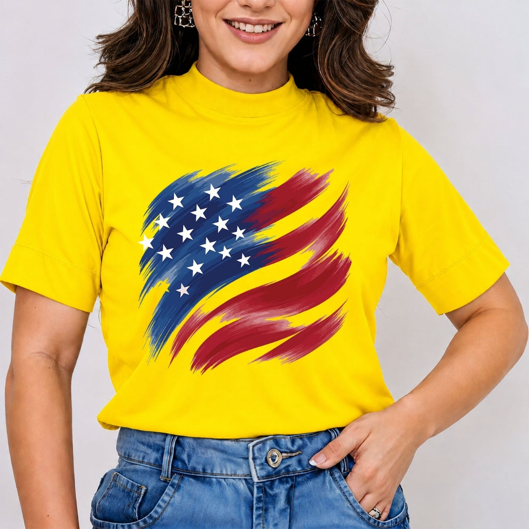A person wearing a bright yellow t-shirt featuring a stylized brushstroke American flag graphic.