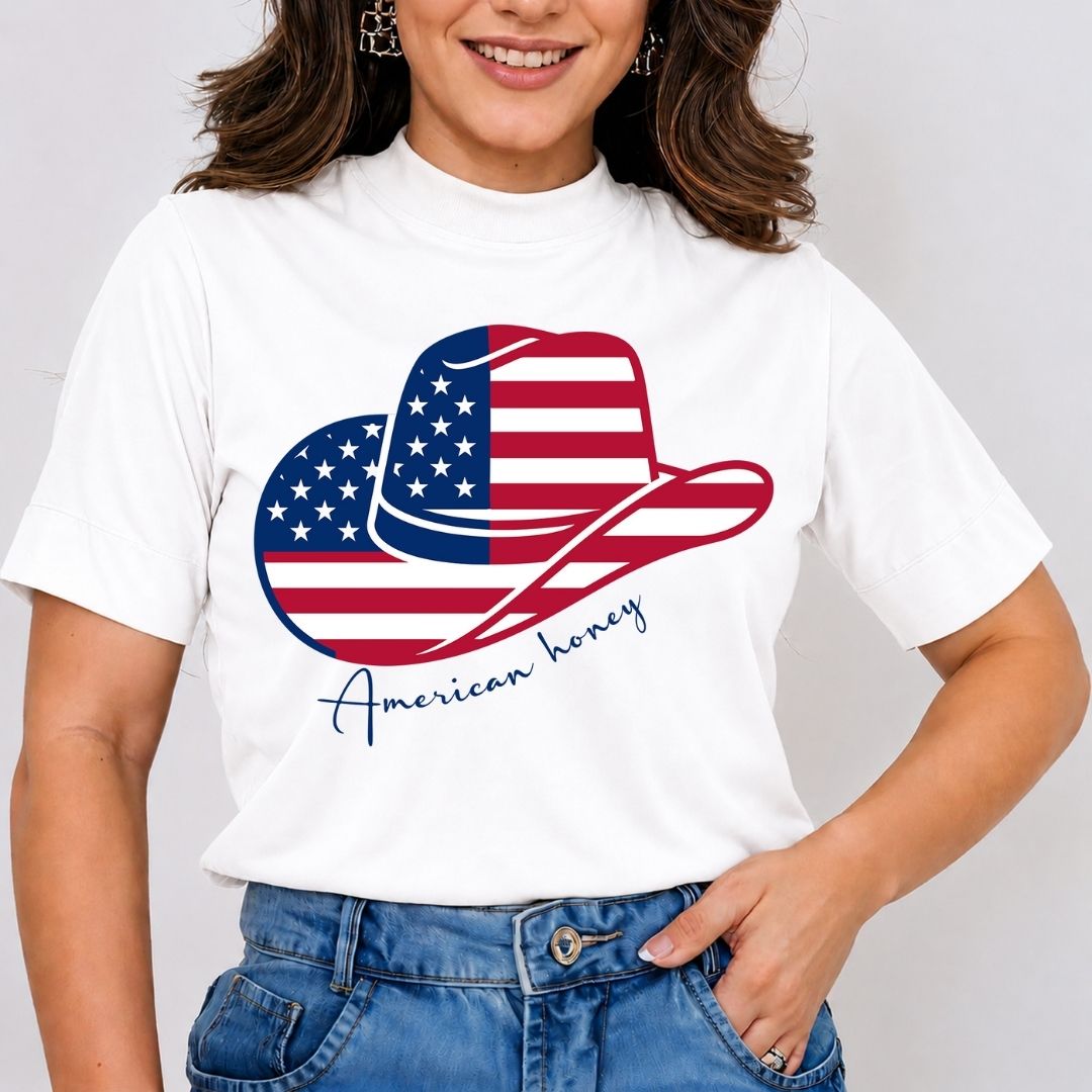 A smiling woman wearing a white mock-neck t-shirt featuring an American flag patterned cowboy hat graphic with the script text "American honey".