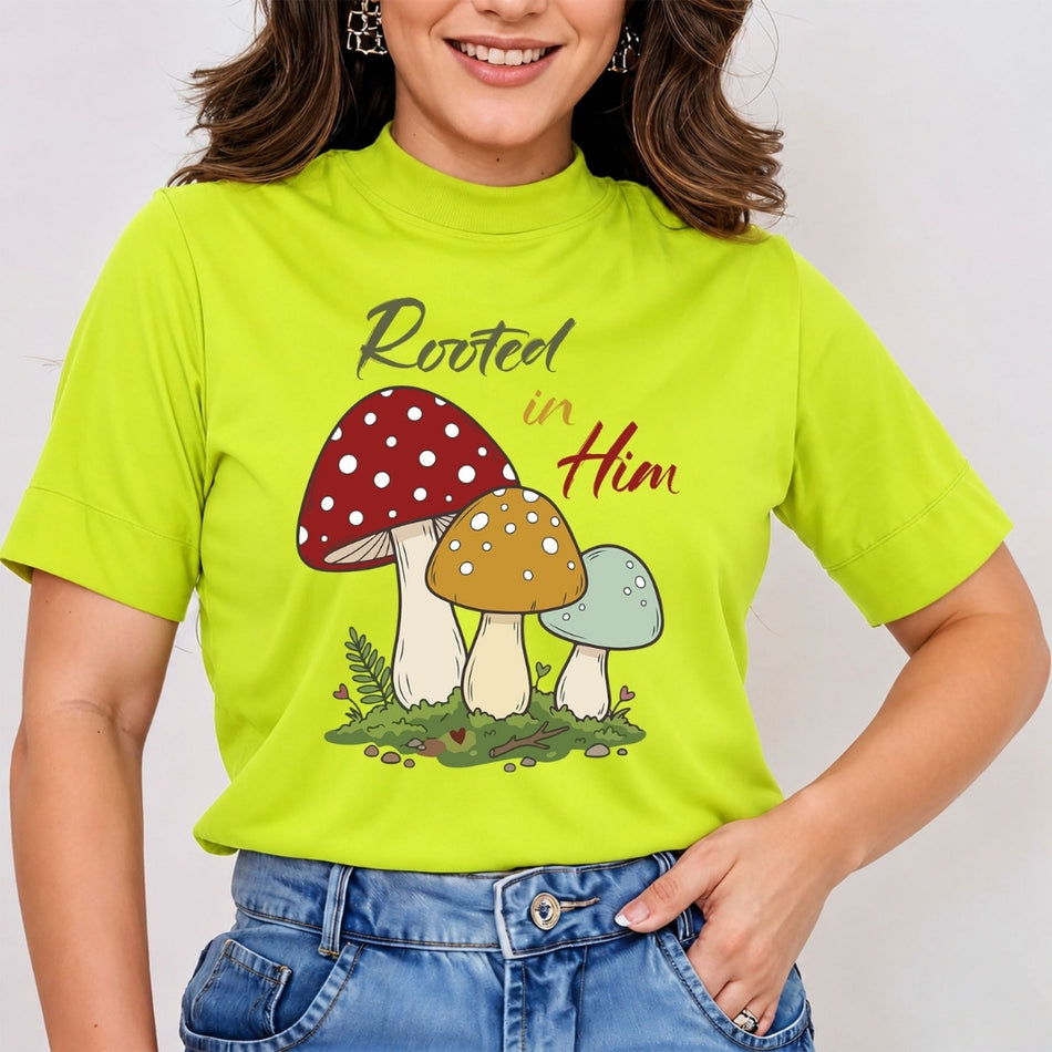 A woman wearing a bright lime green mock-neck t-shirt with a graphic of three colorful mushrooms and the text 'Rooted in Him'.