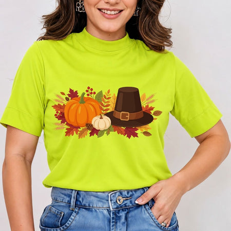 Person wearing a bright green t-shirt with a Thanksgiving design featuring pumpkins and a pilgrim hat.