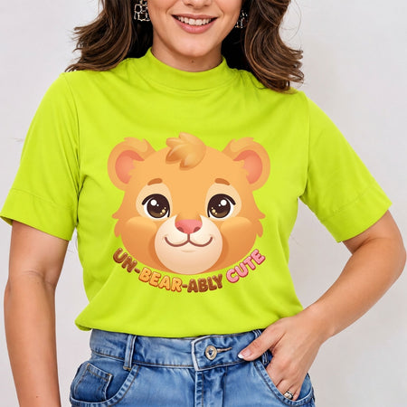 Woman wearing a lime green mock neck t-shirt featuring an adorable cartoon bear face graphic with text reading Un-Bear-Ably Cute.