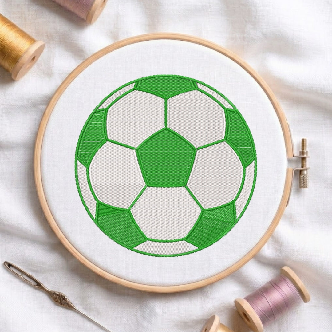 Embroidery hoop with a green and white soccer ball design on a light background.