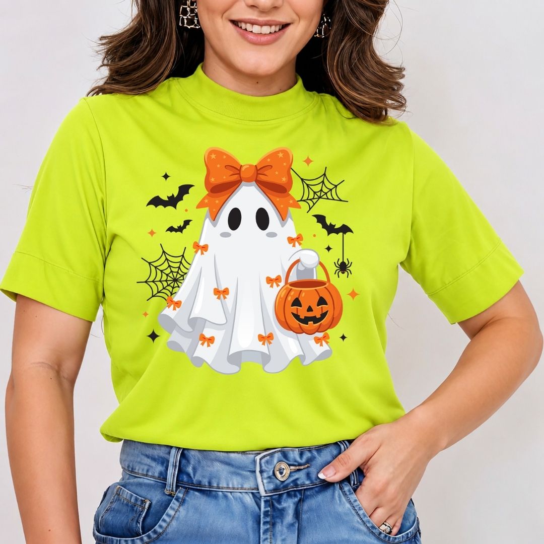 Woman wearing a bright green t-shirt featuring a cute Halloween ghost sublimation graphic with an orange bow and a pumpkin bucket.