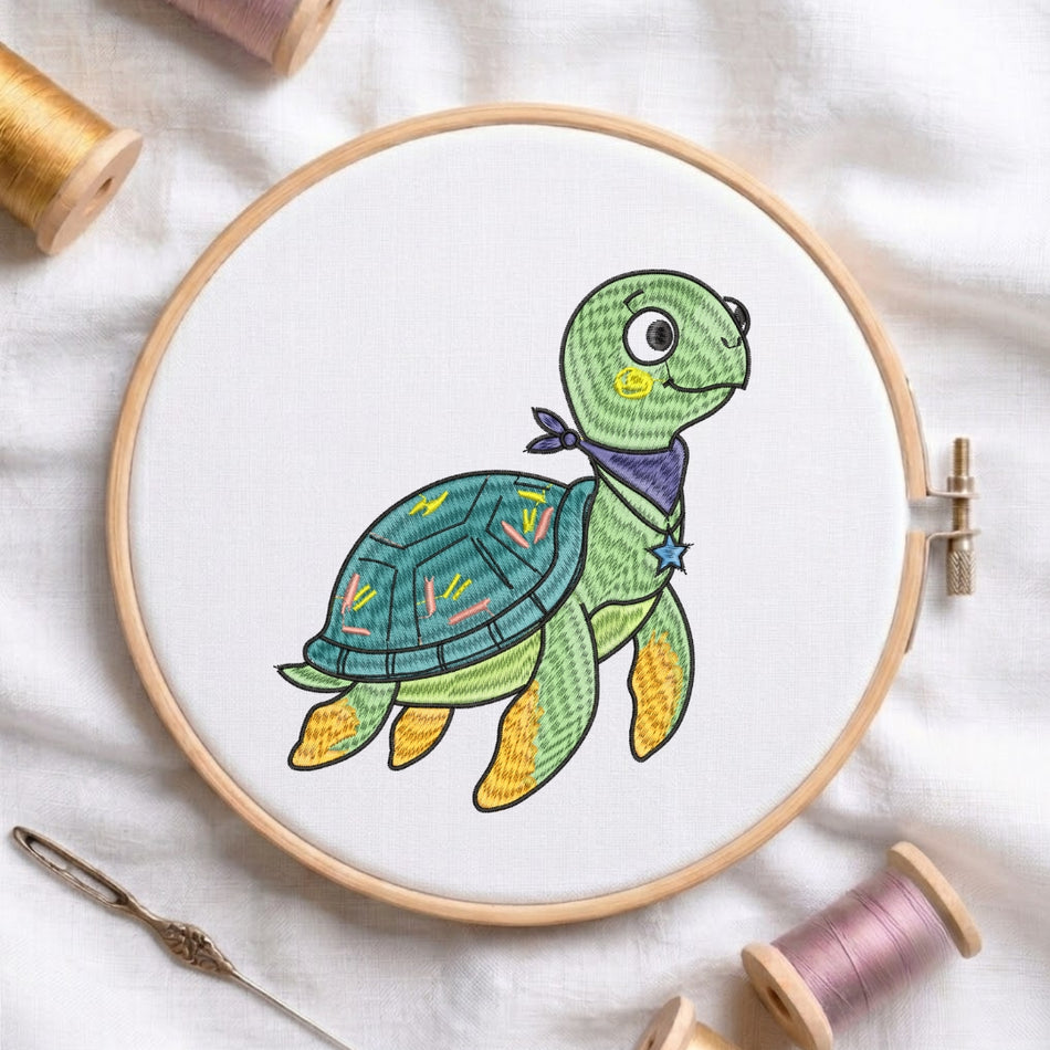 Embroidery hoop with a colorful turtle design on a white fabric background.