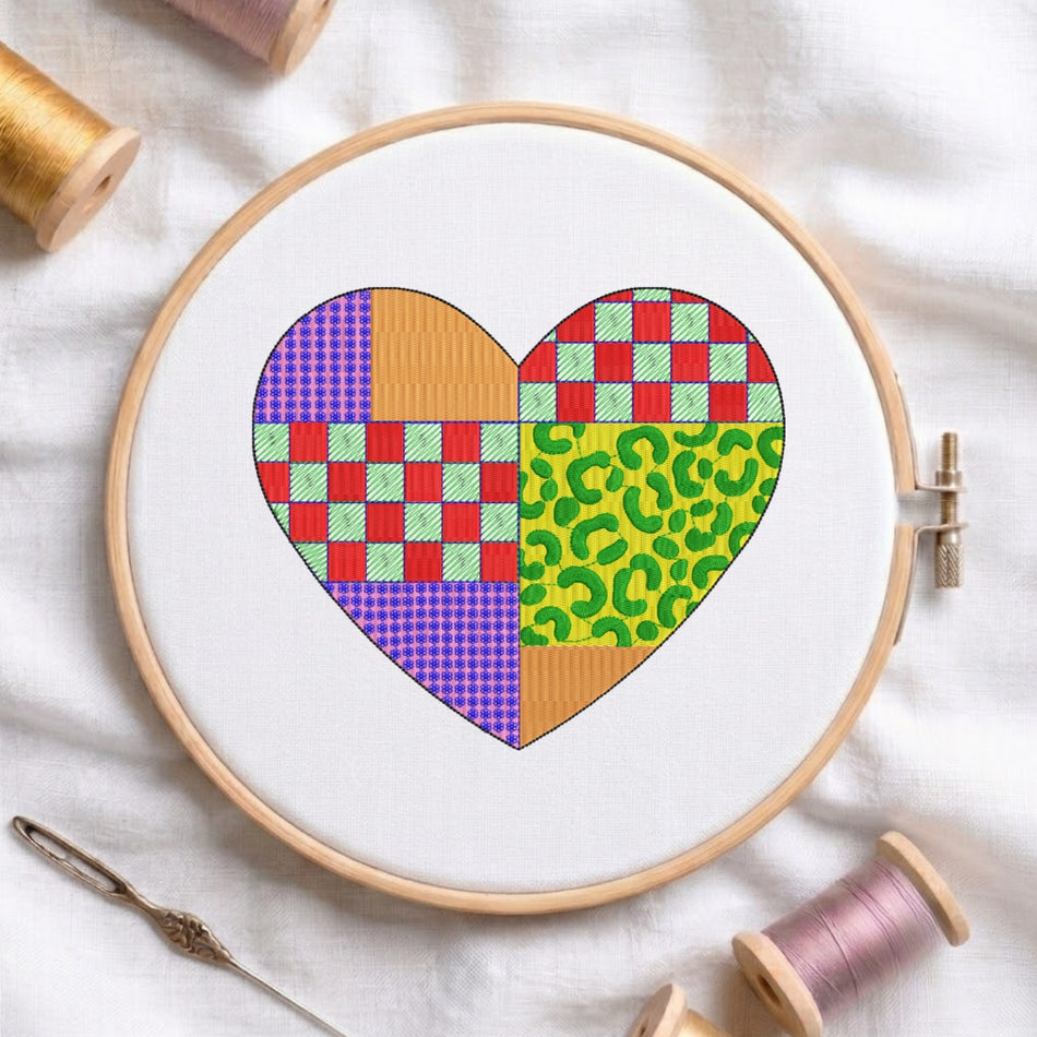 A neatly folded white t-shirt featuring a heart design made of colorful patchwork patterns, including checkered, leopard print, and solid textures.