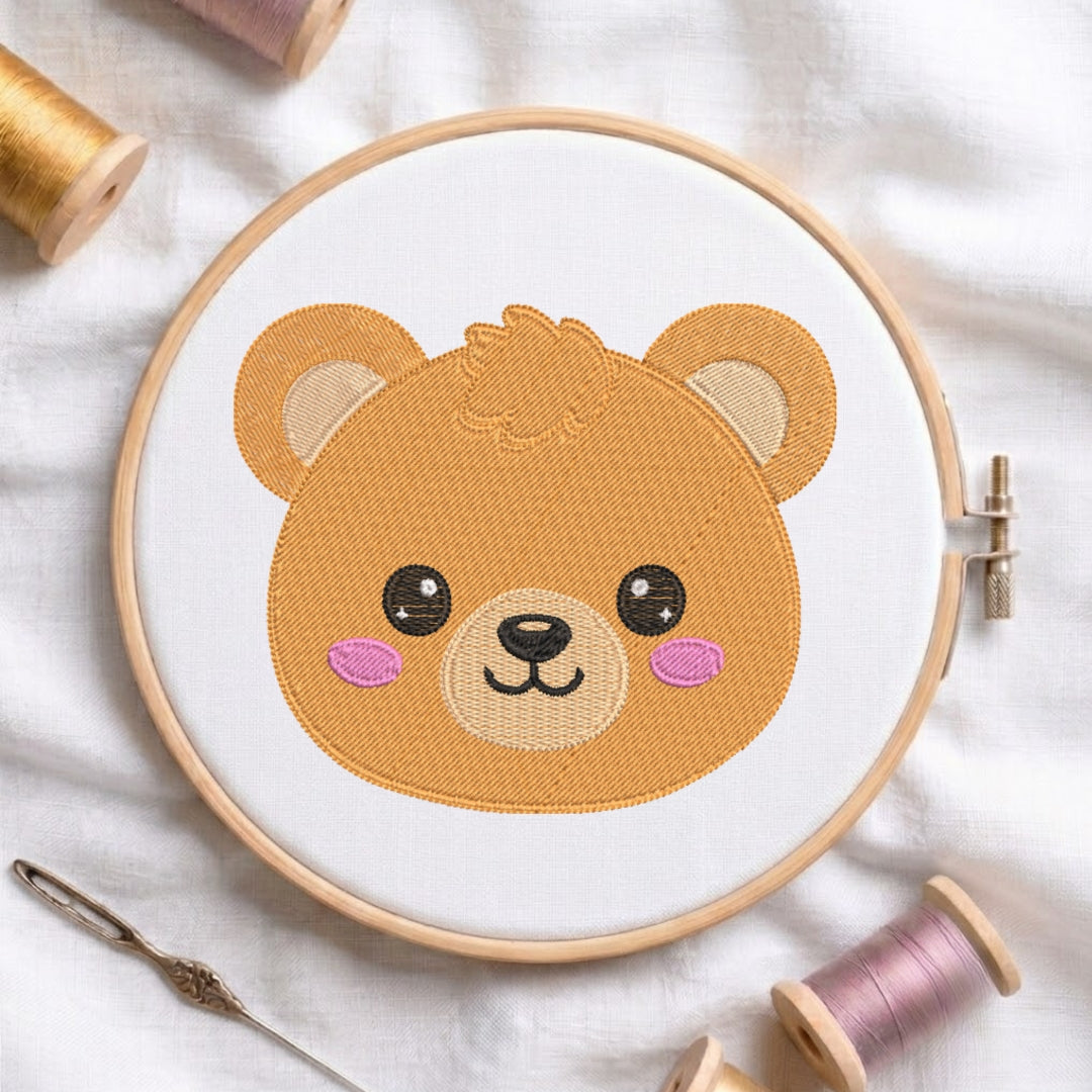 Embroidery hoop with a teddy bear design on a white fabric background