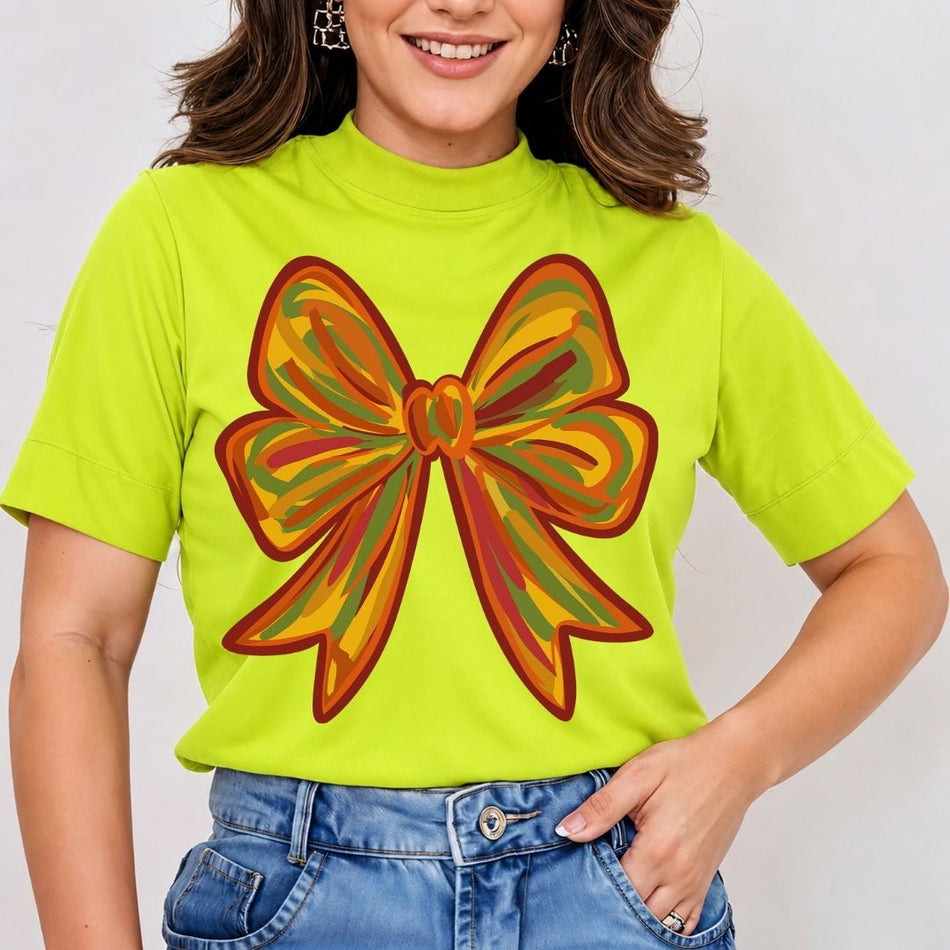 Person wearing a bright green t-shirt with a large orange and red bow design on a plain background