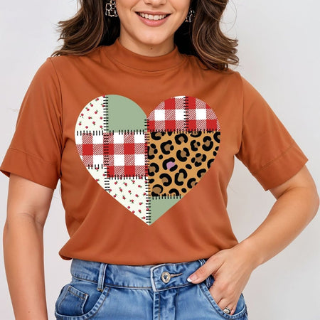 Person wearing a brown t-shirt with a heart-shaped pattern on a plain background