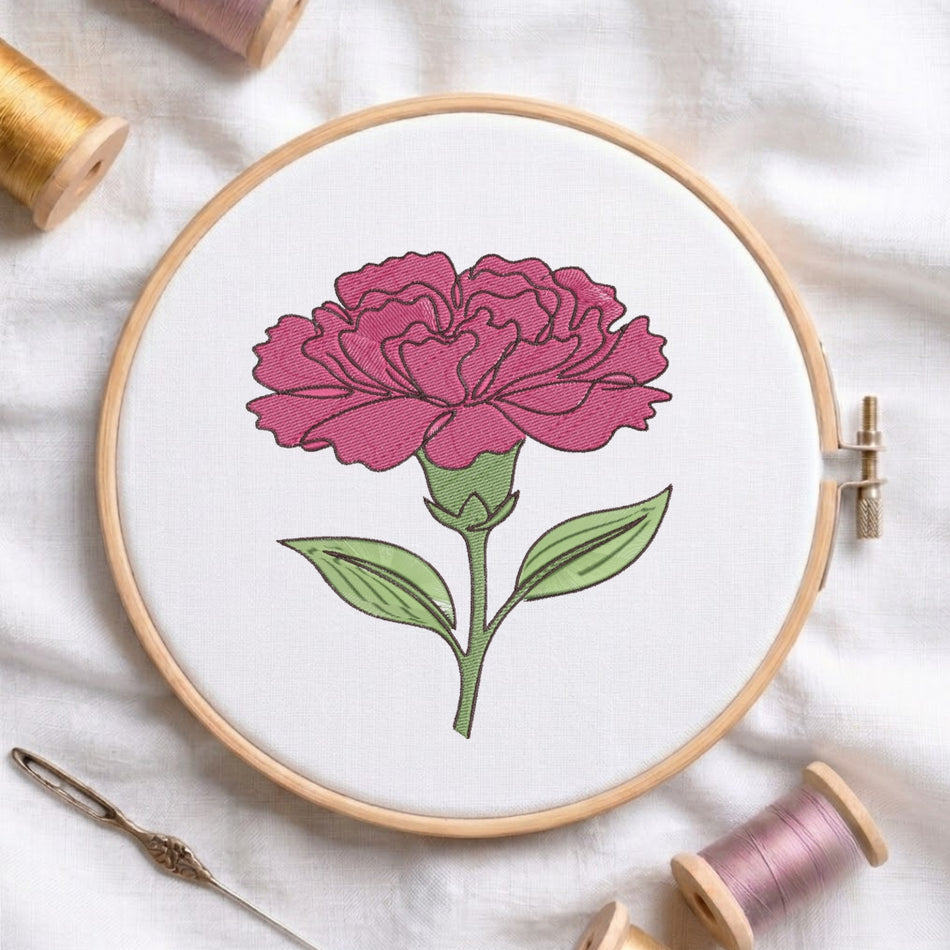 A circular embroidery hoop holding white fabric with a stitched pink flower and green stem, surrounded by spools of thread and a needle on a white fabric background.