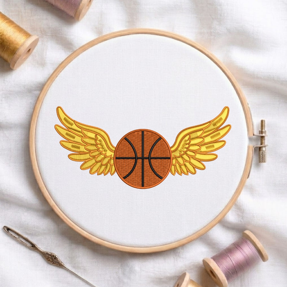 Embroidery hoop with a basketball design featuring wings on a white fabric background.